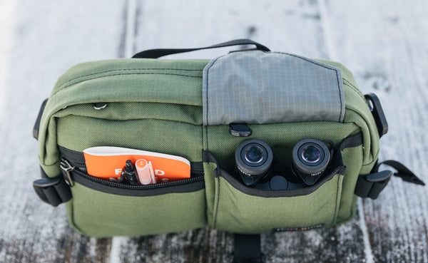Small bincoulars in the front pocket of the LPD; a notebook and pens as well.